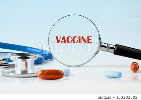 A magnifying glass emphasizes the word vaccine next to colorful pills and a stethoscope, reflecting the importance of vaccines in promoting health awareness and prevention A magnifying glass emphasizes the word vaccine next to colorful pills and a stethoscope, reflecting the importance of vaccines in promoting health awareness and prevention 133202502
