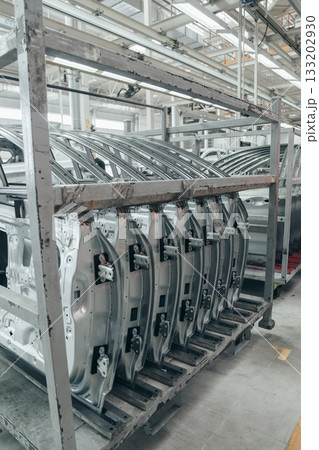 Batch of Unpainted Metal Car Doors Ready for car Assembly in the Welding shop of car assembly plant Batch of Unpainted Metal Car Doors Ready for car Assembly in the Welding shop of car assembly plant 133202930