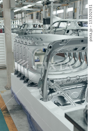 Batch of Unpainted Metal Car Hoods Ready for car Assembly in the Welding Shop of car Assembly Plant Batch of Unpainted Metal Car Hoods Ready for car Assembly in the Welding Shop of car Assembly Plant 133202931