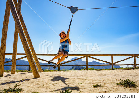 Adult woman having fun on zipline 133203591