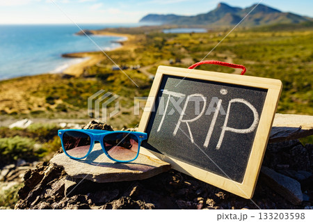 Black board with word trip against sea coast 133203598