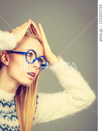 Nerdy woman in big holding head 133203724