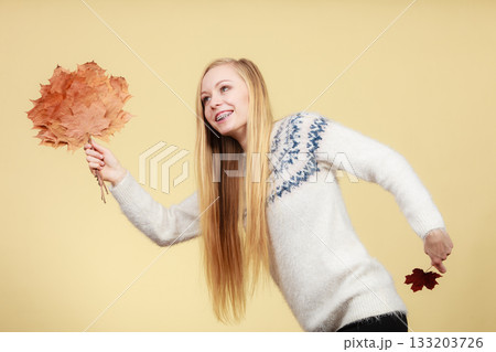 Woman holding bouquet made of autumn leaves 133203726