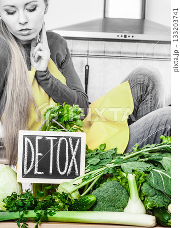 Woman having green diet vegetables, detox sign 133203741