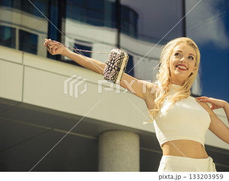 Cheerful fashionable woman in city 133203959