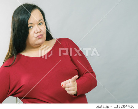 Fat woman pointing with finger Fat woman pointing with finger 133204416