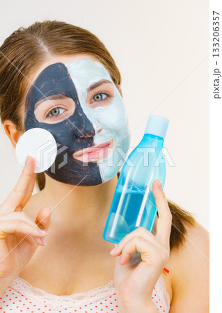 Girl remove black white mud mask from face Girl remove black white mud mask from face 133206357