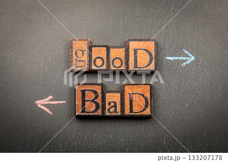 Concept of good and bad choices represented with wooden letter blocks and arrows on chalkboard Concept of good and bad choices represented with wooden letter blocks and arrows on chalkboard 133207178