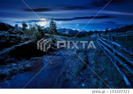 rural scene of mountain landscape in spring at night. mysterious countryside with forested hills in full moon light. beautiful valley sustainable development under sky with dark clouds rural scene of mountain landscape in spring at night. mysterious countryside with forested hills in full moon light. beautiful valley sustainable development under sky with dark clouds 133207321