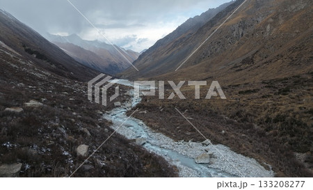 Serene mountain valley with winding river and rocky terrain landscape Serene mountain valley with winding river and rocky terrain landscape 133208277