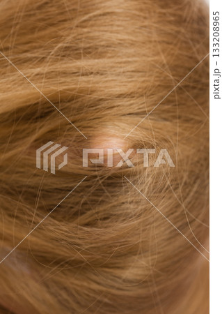 Woman face covered with blonde long hair 133208965