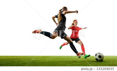 Female football player leaping to shoot ball with determined emotion Female football player leaping to shoot ball with determined emotion 133209035