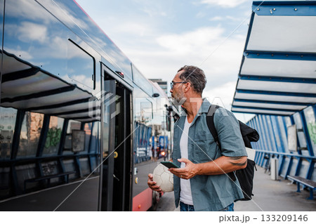 Mature man entering bus. Concept of public transportation. Mature man entering bus. Concept of public transportation. 133209146