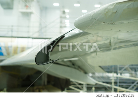 Wingtip designed for aerodynamic efficiency showcased in a modern aerospace facility during a scheduled maintenance check 133209219