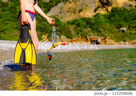 Woman with flippers snorkeling tube on beach Woman with flippers snorkeling tube on beach 133209686