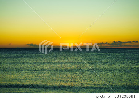 Sunset or sunrise over sea surface 133209691