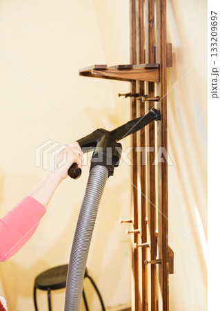 Woman cleaning dust on hanger 133209697
