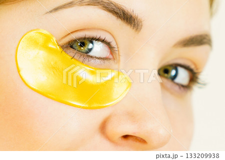 Woman with gold patches under eyes Woman with gold patches under eyes 133209938