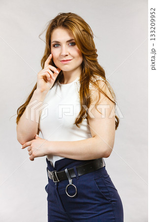 Woman wearing high waist trouser with belt Woman wearing high waist trouser with belt 133209952