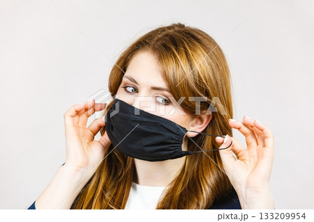 Female using protective face mask. Female using protective face mask. 133209954