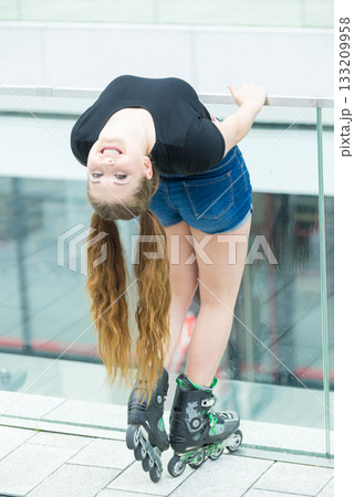 Young woman riding roller skates Young woman riding roller skates 133209958
