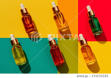 A stylized flat lay of liquid vitamins and tinctures with droppers, emphasizing precise dosage and daily health rituals. 133210185