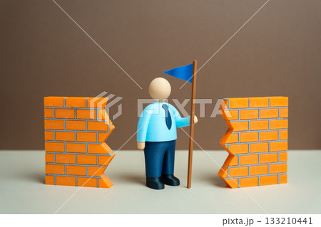 A leader with a blue flag breaks barriers and overcomes difficulties. Leadership and the art of leading. Business success, corporate training, motivation, personal achievement, overcoming challenges. 133210441