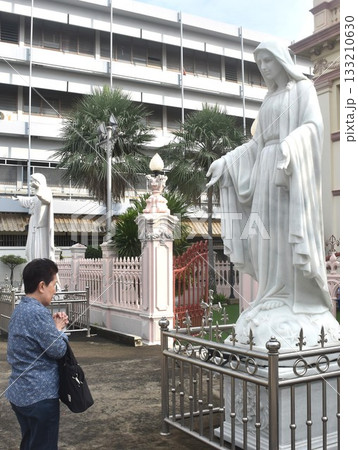 Asian elder woman standing and pay respect front of Santa Cruz church ancient community of Portuguese Christian travel location in Thailand Asian elder woman standing and pay respect front of Santa Cruz church ancient community of Portuguese Christian travel location in Thailand 133210630