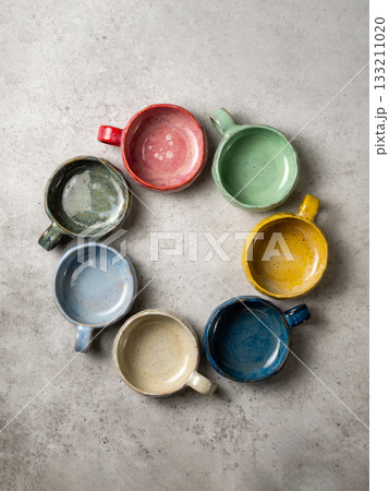 Overhead View of Colorful Ceramic Bowls. Handmade craft ceramics cups, top view. Arrangement of circle composition made from craft ceramics cups Overhead View of Colorful Ceramic Bowls. Handmade craft ceramics cups, top view. Arrangement of circle composition made from craft ceramics cups 133211020