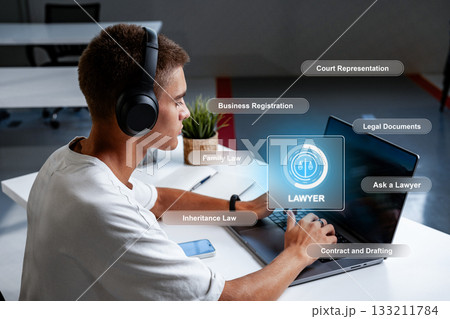 Lawyer working on legal documents and providing online consultation in office setting 133211784