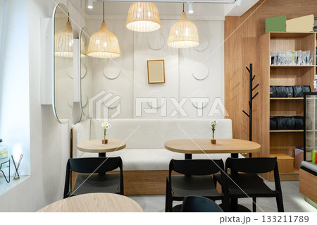Cozy and modern cafe interior with warm...の写真素材 [133211789] - PIXTA