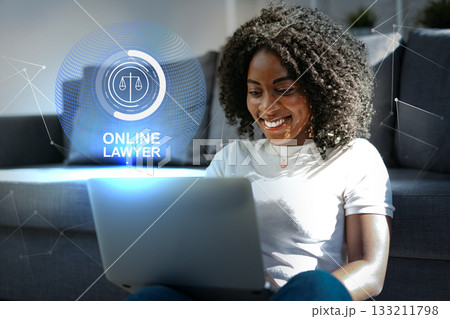 Woman using laptop to consult with online lawyer in modern living room setting 133211798