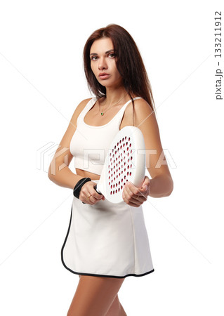 Young woman prepares to play paddle tennis in sporty outfit and focused expression 133211912