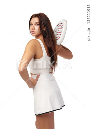 Young woman shows confidence in sportswear with paddle in hand during practice session Young woman shows confidence in sportswear with paddle in hand during practice session 133211918