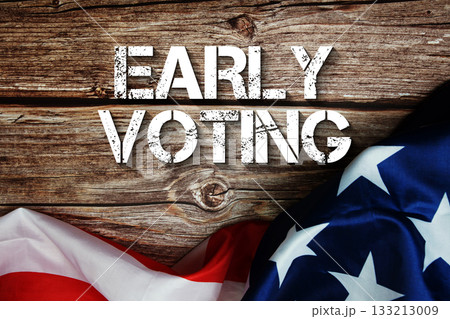 Early Voting text message with USA flag on wooden background Early Voting text message with USA flag on wooden background 133213009