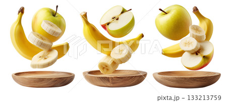Whole and sliced apple and banana served on round wooden plate, isolated on white transparent background. 133213759