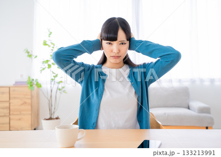 耳を塞ぐ若い女性 133213991