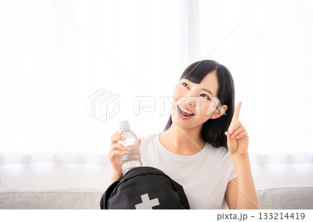 防災リュックを持つ若い女性 133214419