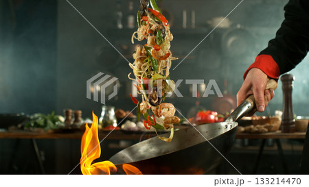 Freeze Motion of Flying Asian Meal with Vegetable and Prawns into Wok Pan Freeze Motion of Flying Asian Meal with Vegetable and Prawns into Wok Pan 133214470