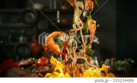 Freeze Motion of Flying Asian Meal with Vegetable and Prawns into Wok Pan Freeze Motion of Flying Asian Meal with Vegetable and Prawns into Wok Pan 133214489