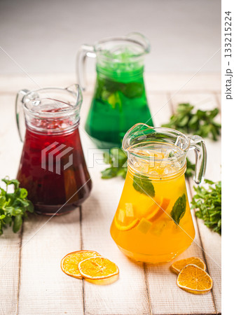 Colorful fruit lemonades in pitchers Colorful fruit lemonades in pitchers 133215224