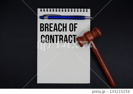 Breach of Contract text written on notepad with gavel on black background Breach of Contract text written on notepad with gavel on black background 133215258