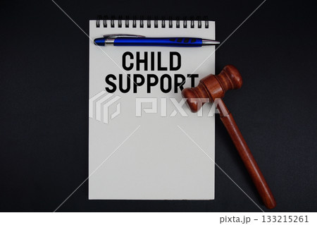 Child Support text written on notepad with gavel on black background Child Support text written on notepad with gavel on black background 133215261