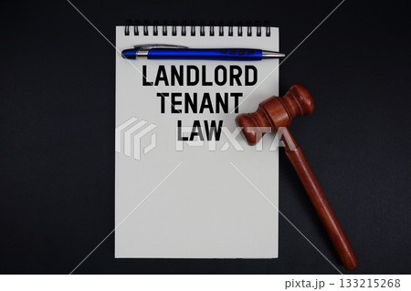 Landlord Tenant Law text written on notepad with gavel on black background Landlord Tenant Law text written on notepad with gavel on black background 133215268
