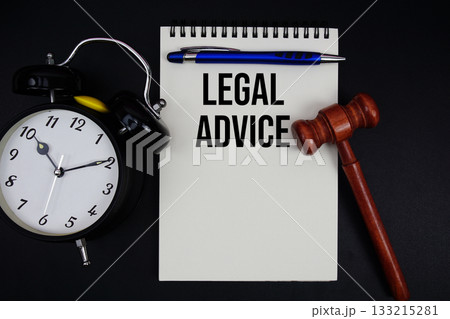 Legal Advice text written on notepad with gavel and alarm clock on black background 133215281