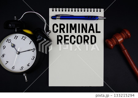 Criminal Record text written on notepad with gavel and alarm clock on black background 133215294
