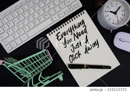 Everything You Need, Just A Click Away text written on notepad with keyboard and trolley shopping cart on black background 133215372
