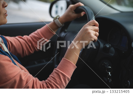 Woman Driving Car With Hands On Steering Wheel Inside Vehicle For Safe, Focused Travel 133215405