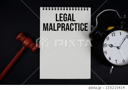 Legal Malpractice text written on notepad with gavel and alarm clock on black background Legal Malpractice text written on notepad with gavel and alarm clock on black background 133215414