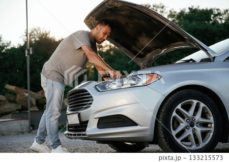 Problem, fixing and repairing the broken automobile. Man is with his car outdoors 133215573